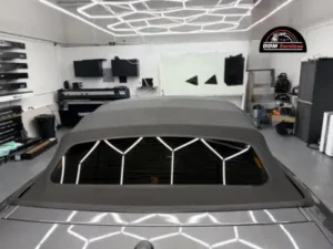 Rear view of a grey convertible showing the tinted back window