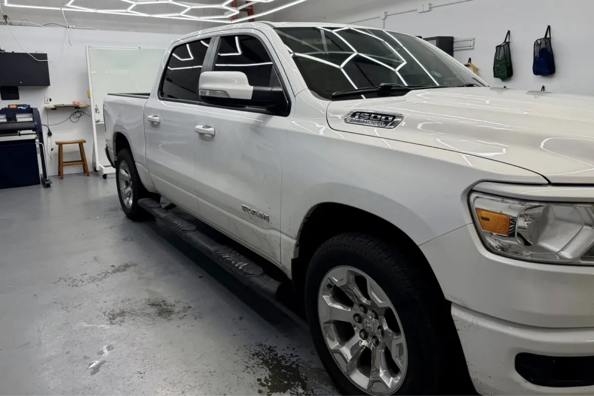 A white RAM 1500 truck inside a shop